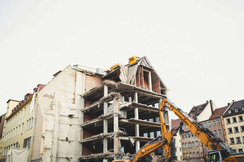 Demolition crane breaking down a building.