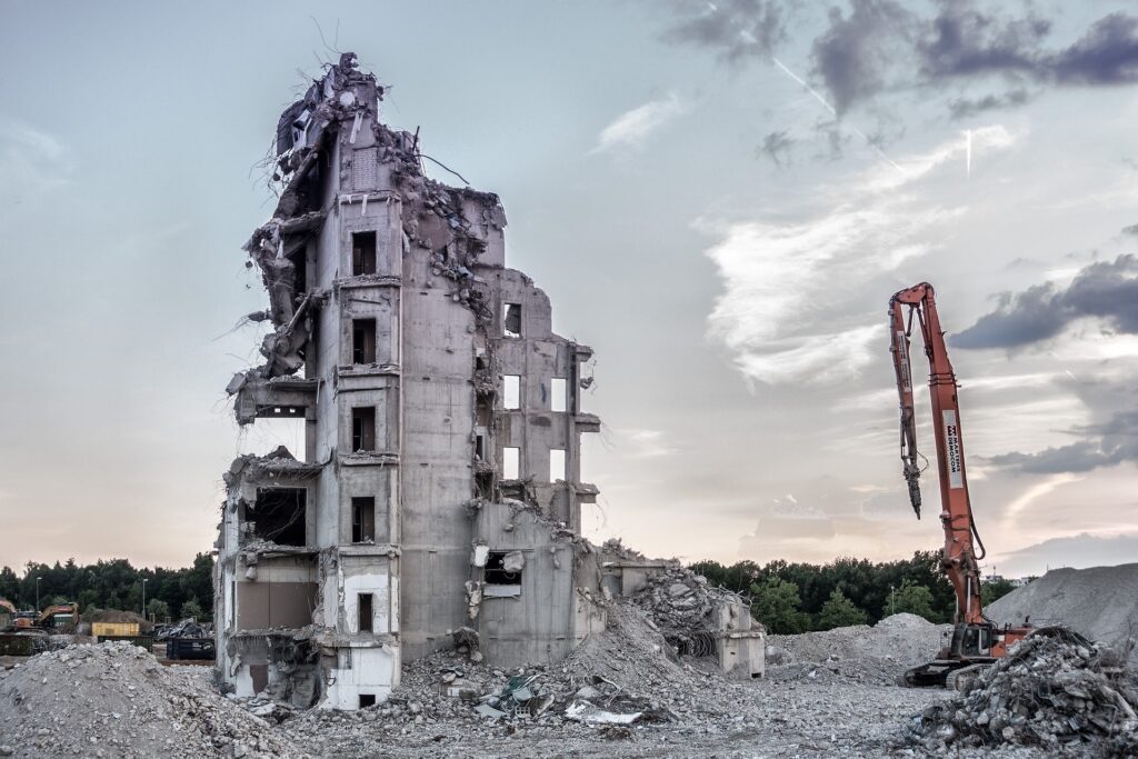 Demolition of a large building with clear skies.
